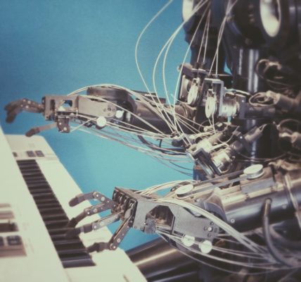 Robot art: robot playing a musical keyboard. Photo by Franck V. on Unsplash