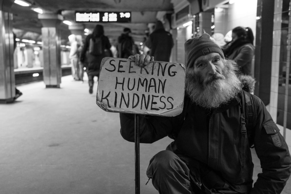 Homeless man seeking human kindness. Photo by Matt Collamer on Unsplash