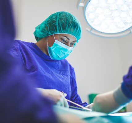 Female vet in operating theatre. Photo by Artur Tumasjan on Unsplash.