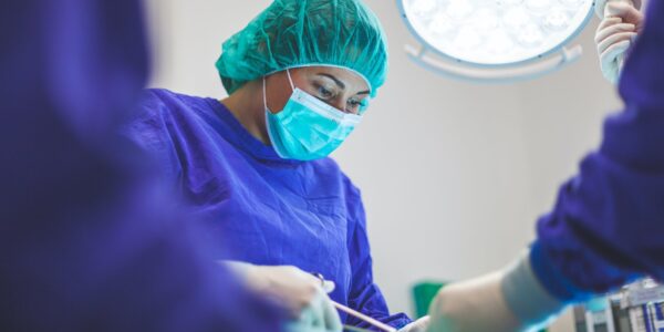 Female vet in operating theatre. Photo by Artur Tumasjan on Unsplash.